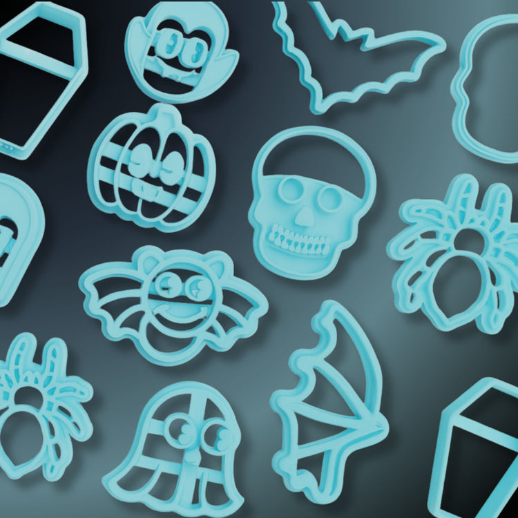 Halloween-themed blue polymer clay cutters featuring fun spooky shapes like a vampire, pumpkin, skull, ghost, bats, wings, spiders, and coffins. Set against a dark gray to black gradient background.
