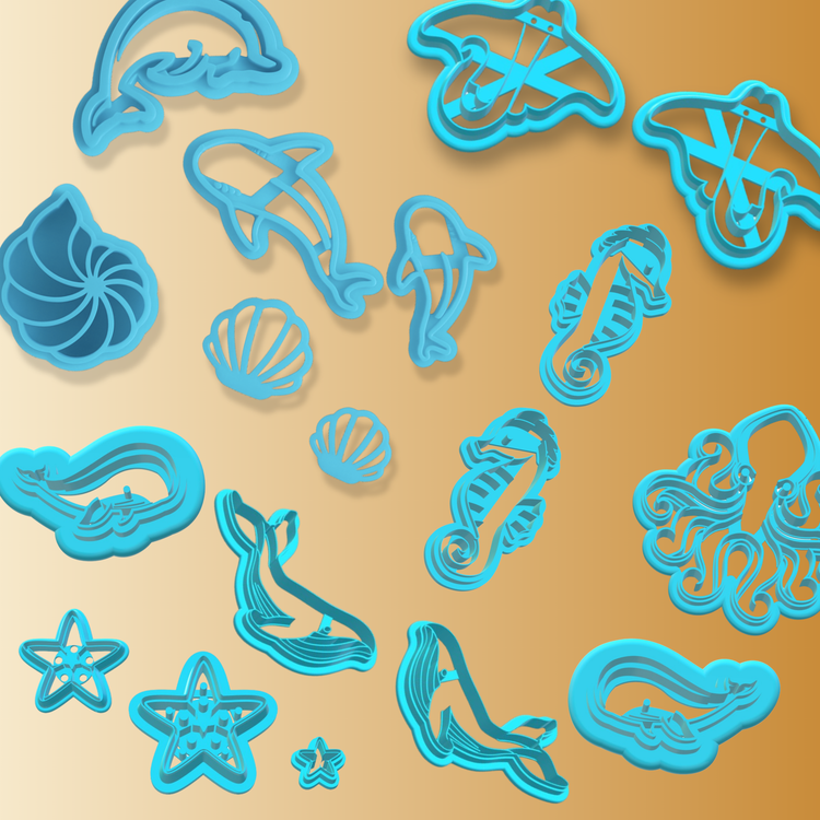 Ocean-themed blue polymer clay cutters featuring dolphins, seashells, and a spiral shell. Set against a warm beige to orange gradient background.