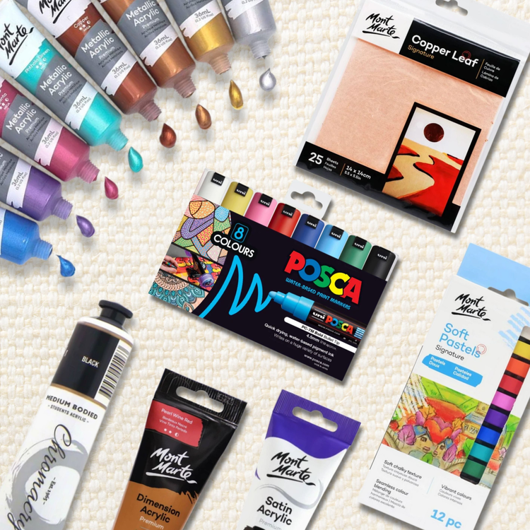 Assorted art supplies on a textured cream background, including Mont Marte metallic, satin, dimension, and classic acrylic paints, soft pastels, copper leaf sheets, and a set of POSCA water-based paint markers in 8 colors