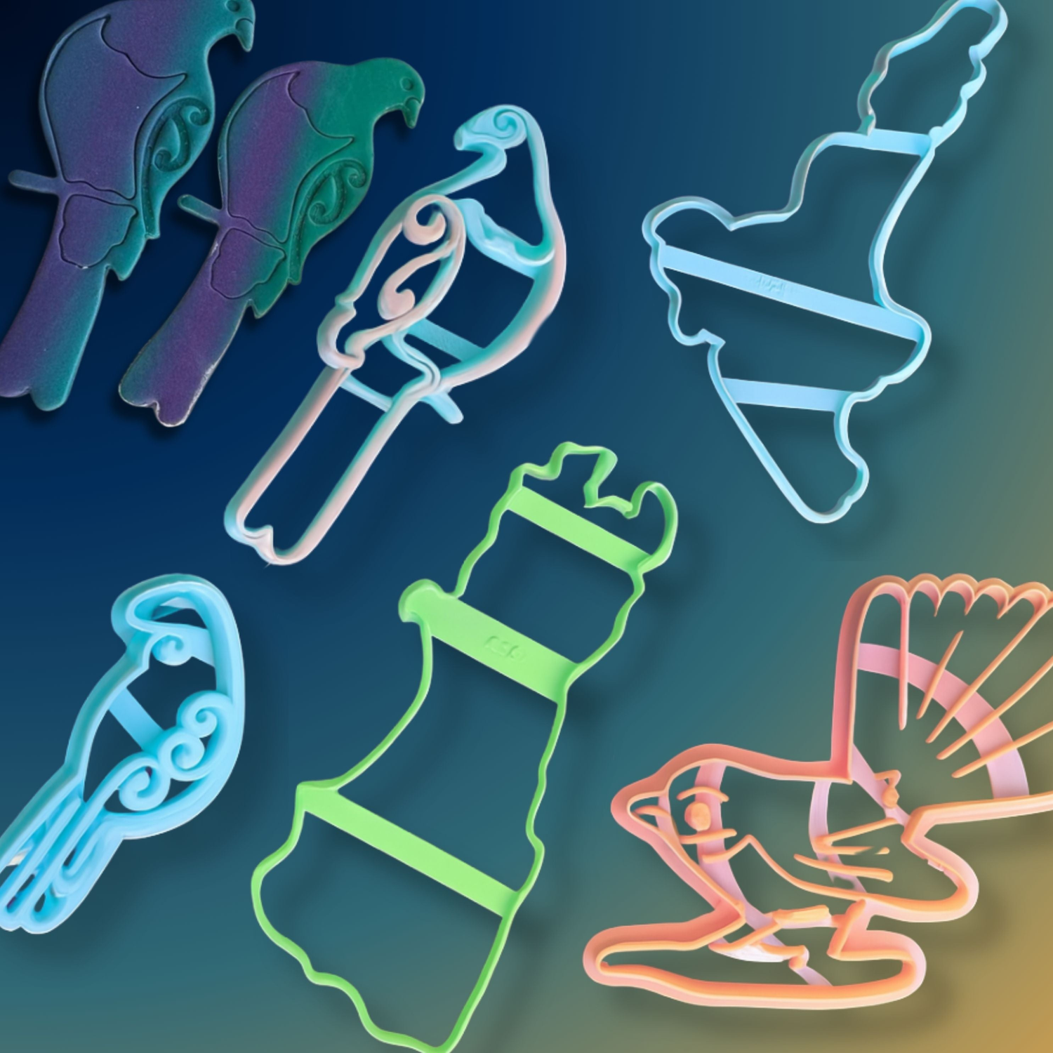 A set of wall hanging cutters in bird and lighthouse shapes in various colors, arranged on a dark blue to yellow gradient background.