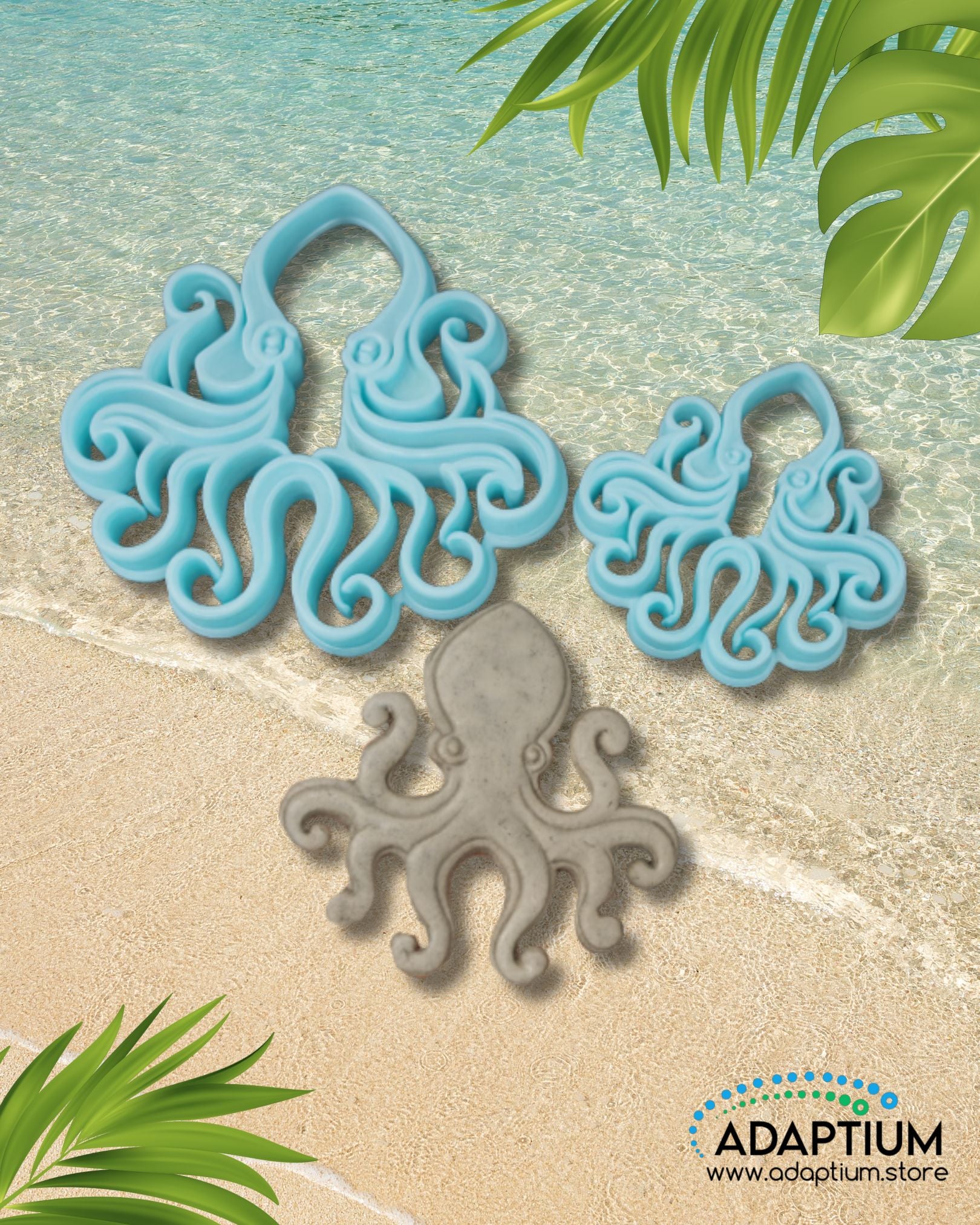 Large and small blue octopus polymer clay cutters with a gray clay octopus piece on sandy beach background with ocean waves and tropical leaves.