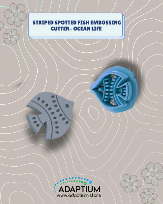 Blue resin fish embossing cutter beside a grey clay fish with curved bands and oval spots.