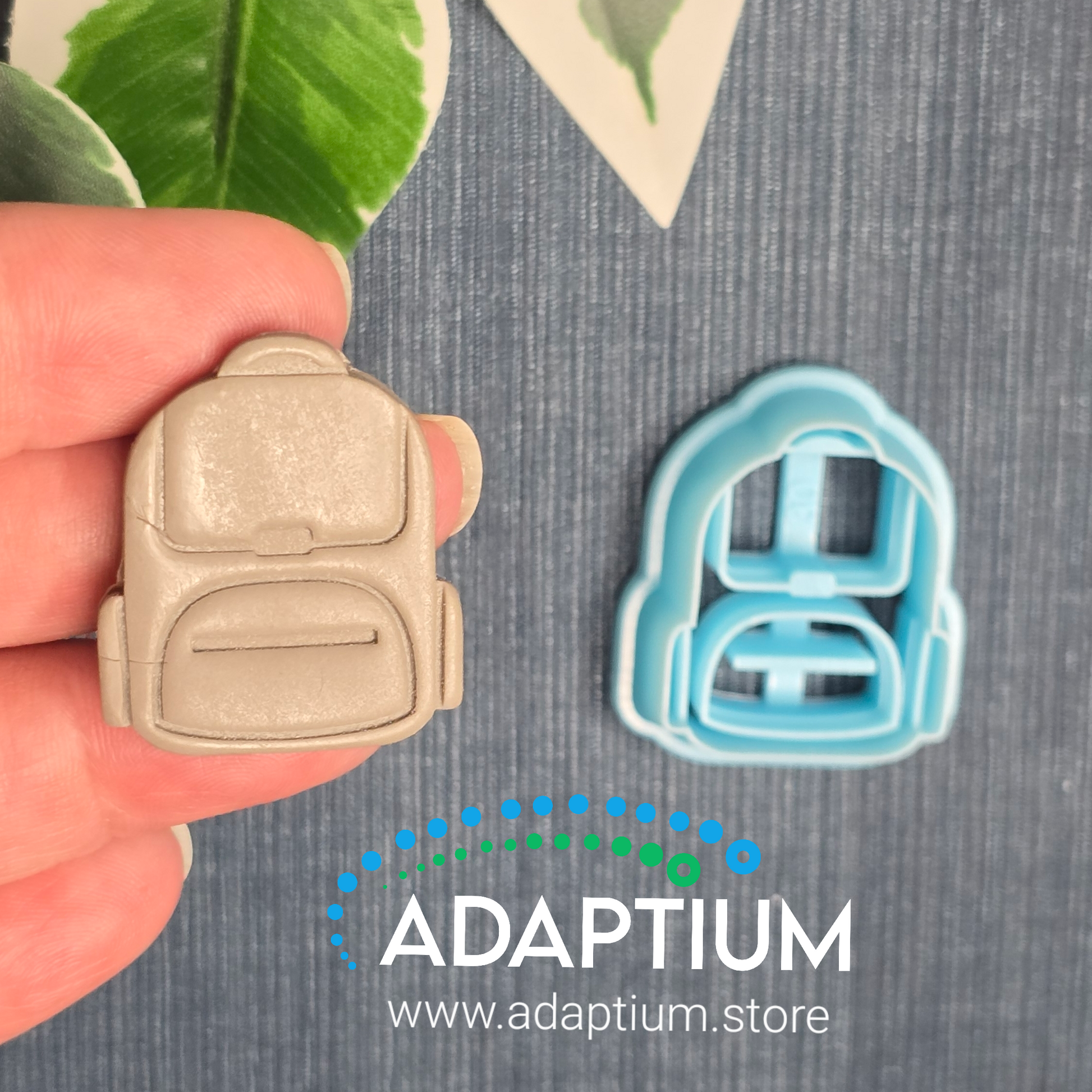 Hand holding a sharp, sky blue Bag resin cutter for polymer Clay
